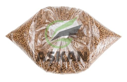 brown buckwheat groats in tied plastic bag isolated on white background