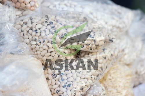 Various cereal groats in plastic bags. Close up of kidney beans in transparent plastic wrapping. Cereals at grocery store.